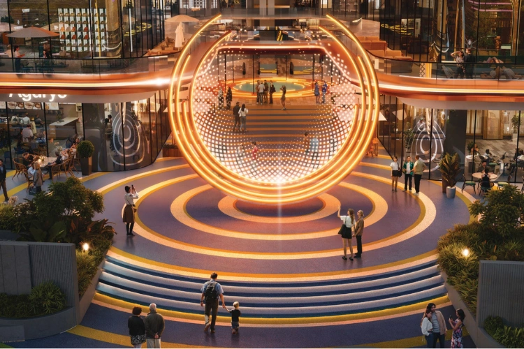 Illuminated circular fountain plaza at dusk