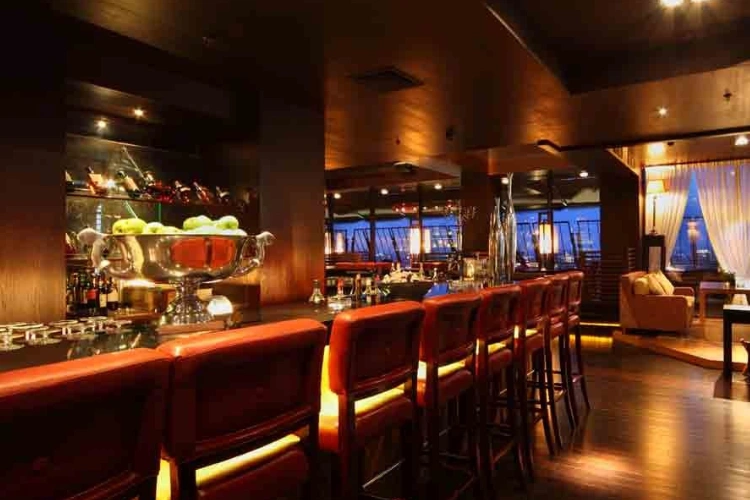 Luxury Bar with Red Leather Stools and Ambient Lighting