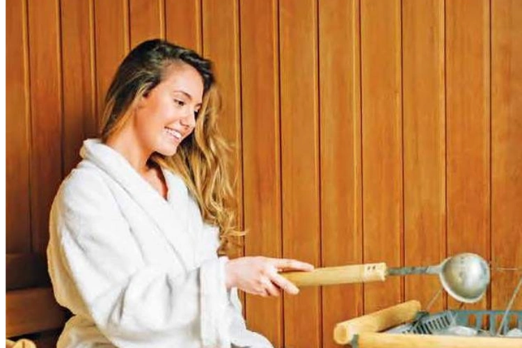 Woman Enjoying Sauna in Wellness Center